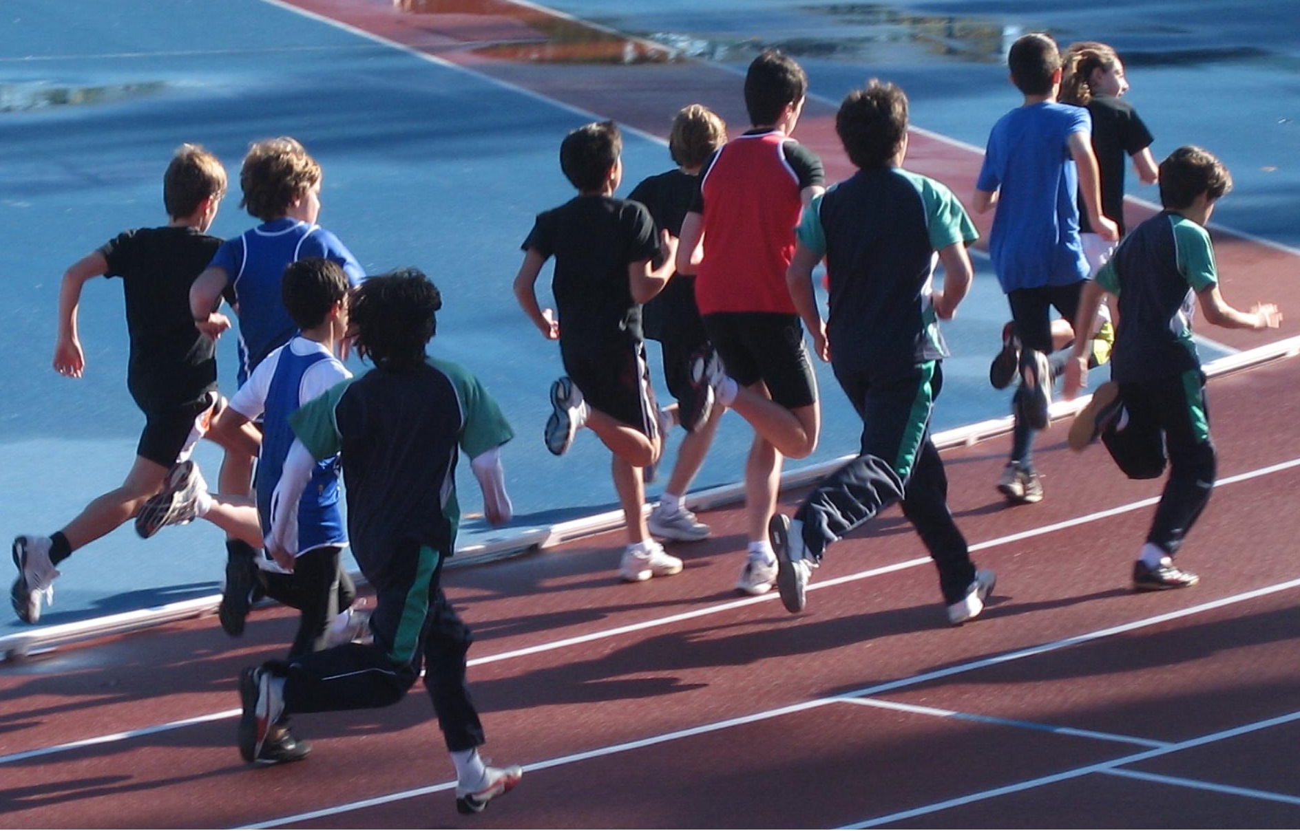 Niños participando en una carrera en pista