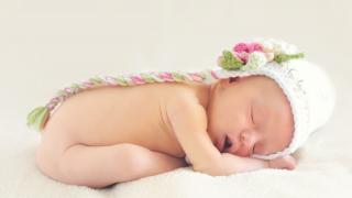 bebé durmiendo con un gorrito de lana