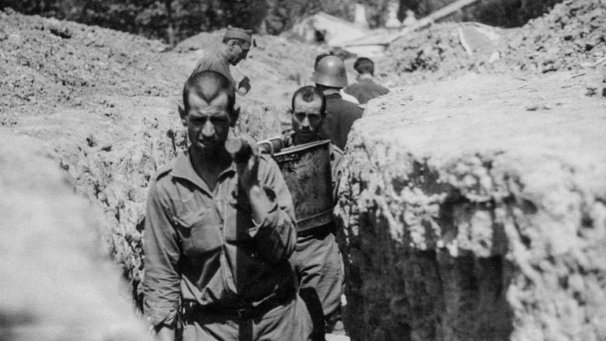 Francoist ranchers carrying food through the trenches of the Madrid front