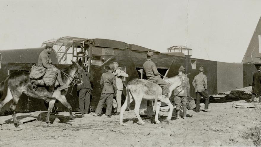 Civilians and soldiers examine the wreckage of a downed Republican plane near Madrid