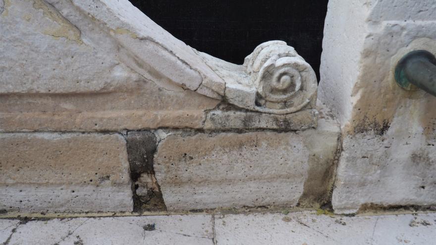 Detail of cracks in the stone of a fountain