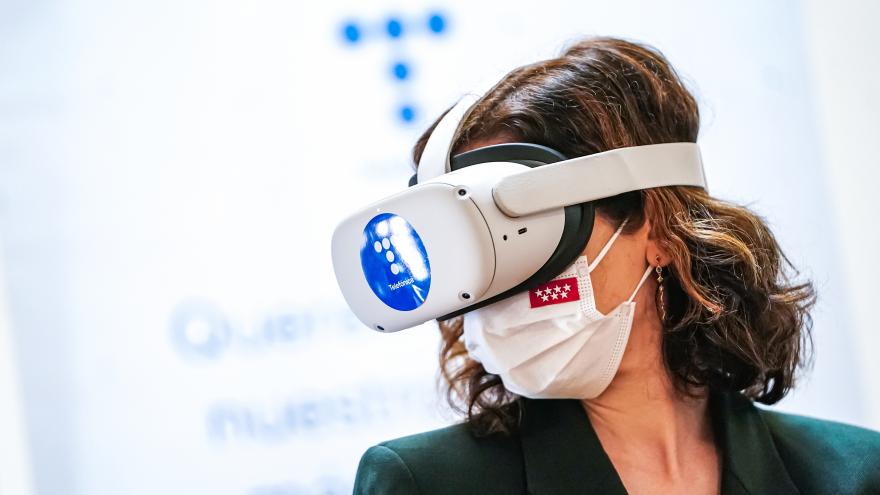 La presidenta utilizando unas gafas virtuales durante el acto