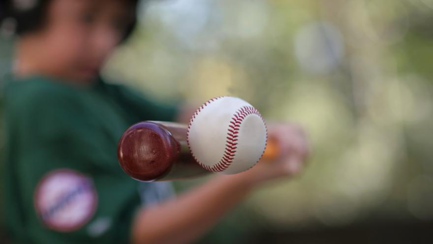 jugador de béisbol en el momento de impactar a la bola con el bate