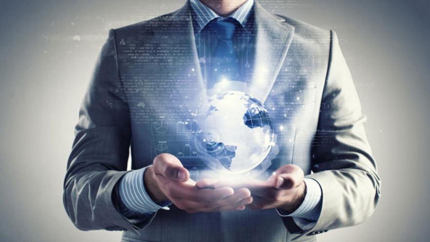 Man in front of a hologram of the world globe