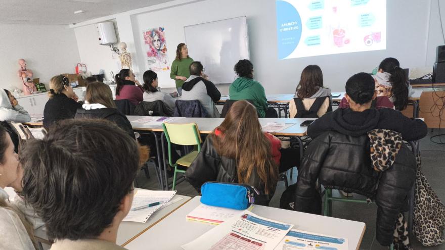 Profesora impartiendo clase a alumnos en un aula