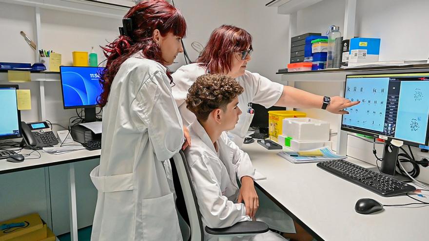 Dos alumnos aprenden ciencia en un laboratorio junto a un sanitario