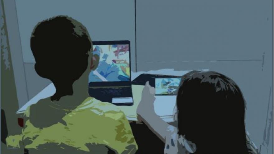 Dos niños frente a la pantalla de un ordenador 