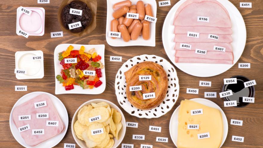 Varios alimentos que tienen identificados en un cartel los aditivos alimentarios que contienen