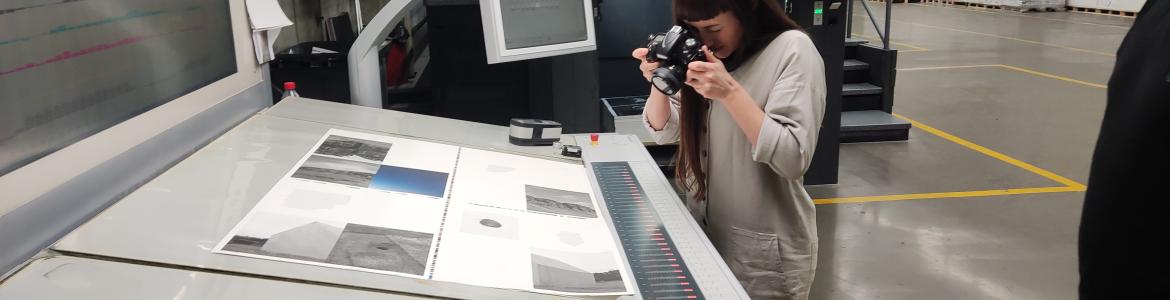 Printing press with sheets of a future photography book