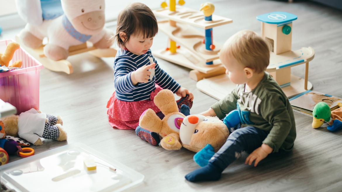 Un niño y una niña jugando en el suelo