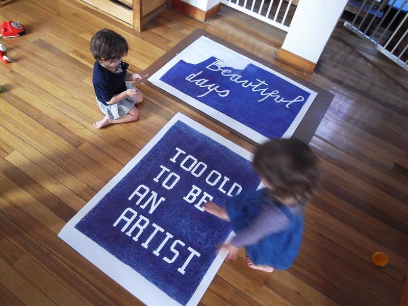 Two children looking at a poster