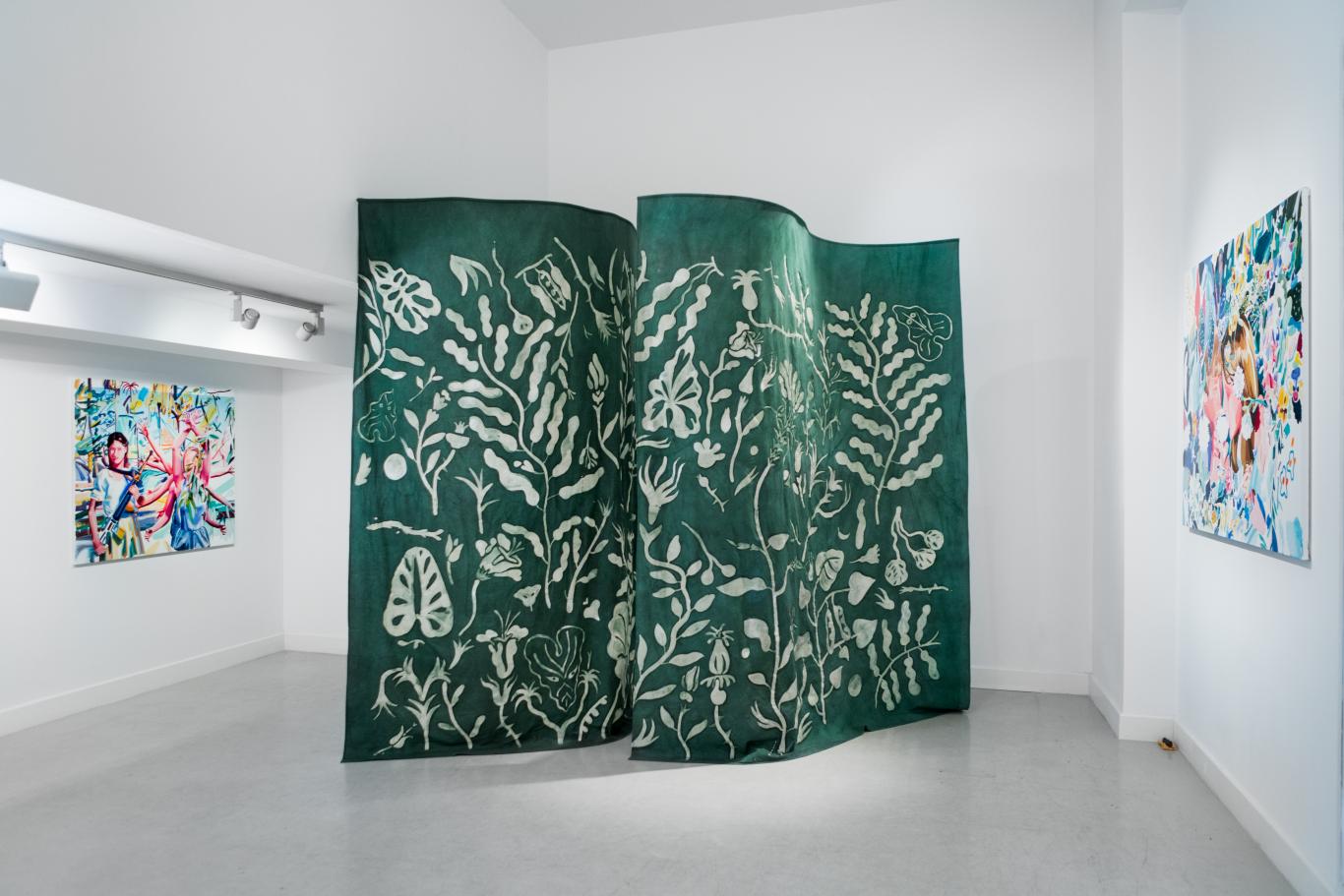 Green fabric curtain with a drawing of branches and leaves simulating a forest