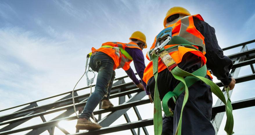 Construction workers perched on a rebar structure