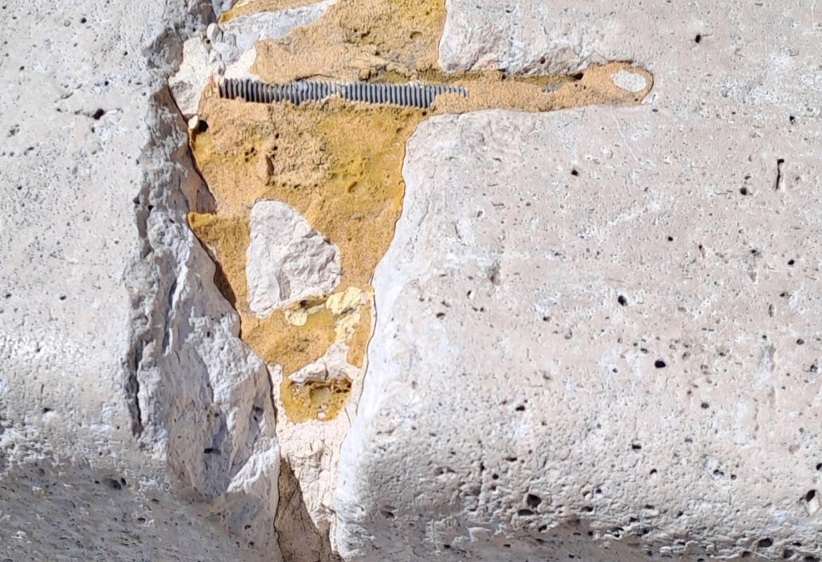 Staple embedded in the stone in poor condition